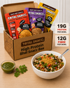 Total Snacc high protein bhel snacc box with various snack packets and a bowl of bhel on a wooden surface.